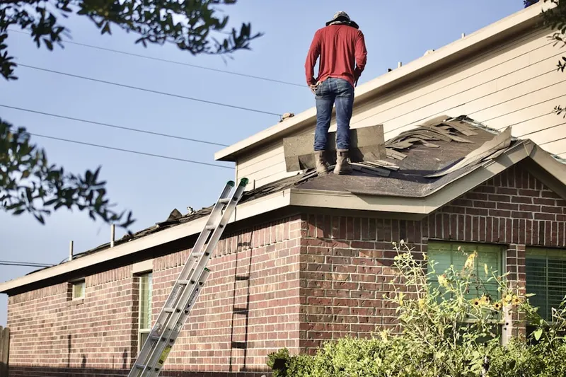 Professional roofer working on a residential roof in Columbia